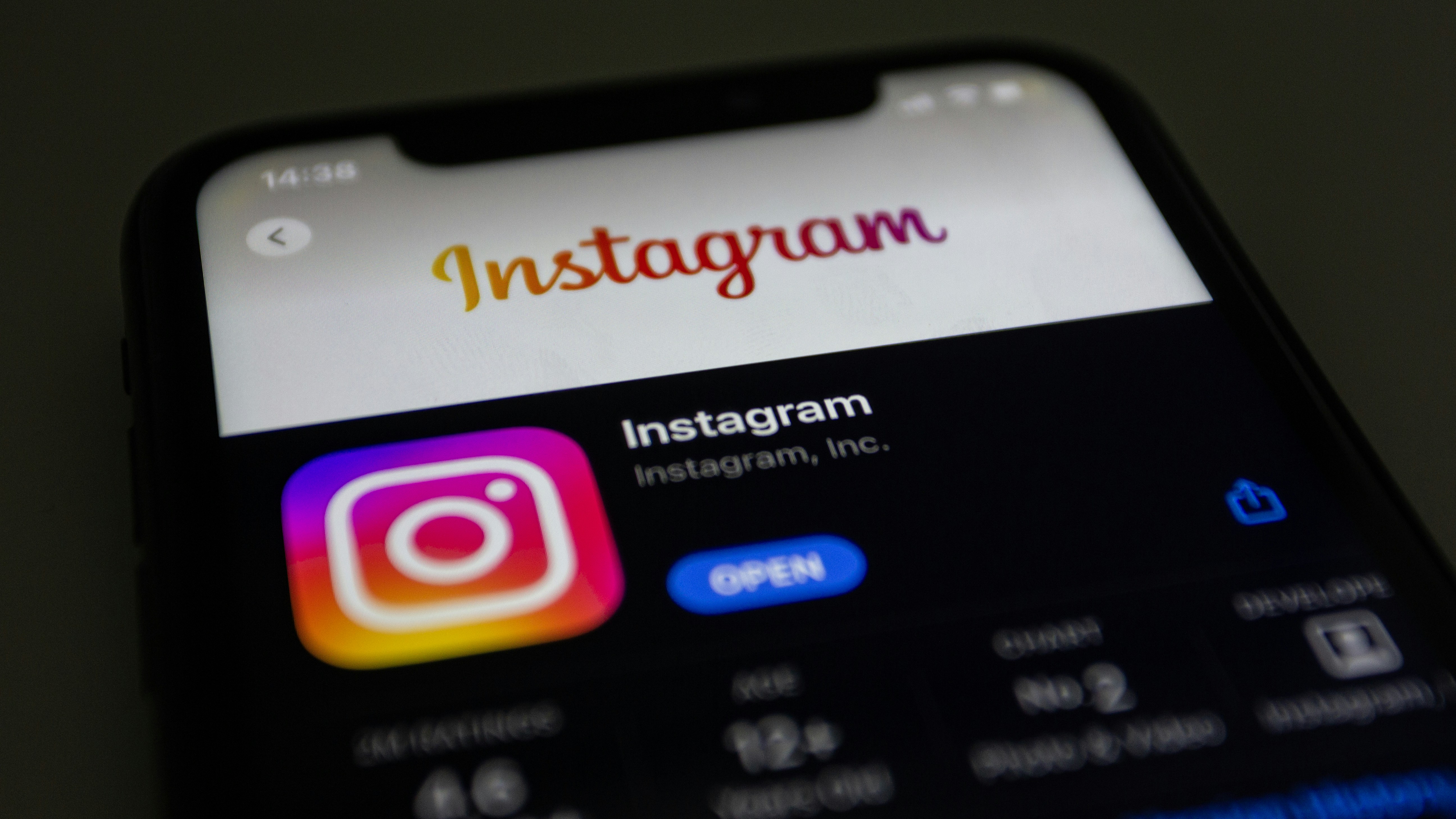 the instagram logo is displayed on an iphone
